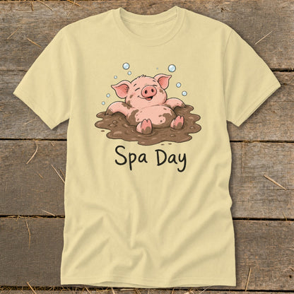 Light yellow t-shirt with a cartoon pig relaxing in mud, text "Spa Day".