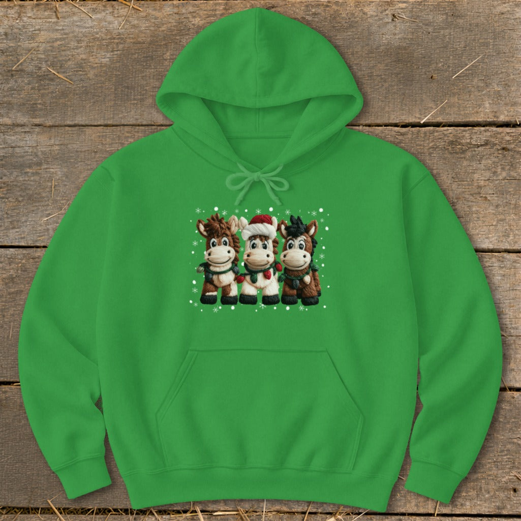 Green hoodie with three cartoon horses wearing festive scarves and Santa hat.