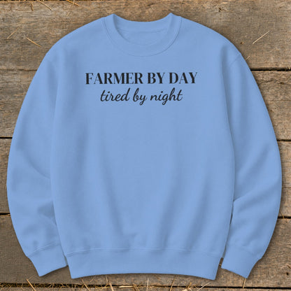 Light blue sweatshirt with black text: Farmer by day, tired by night.