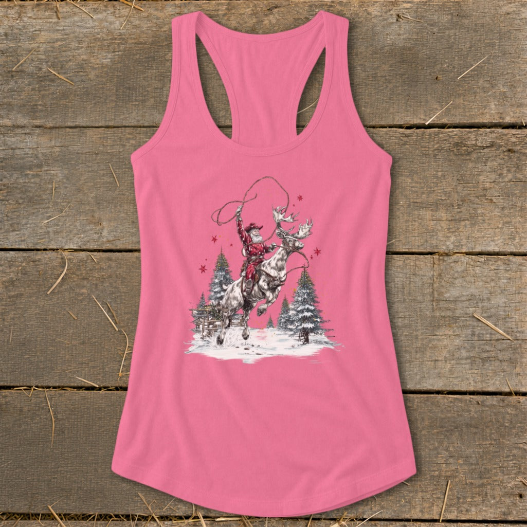 Santa lassoing a moose with Christmas trees and snow scene on a pink tank top.