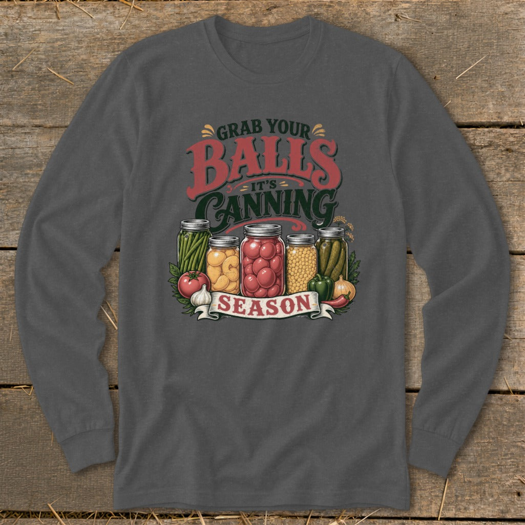 Graphic on dark shirt with jars of canned vegetables and text "Grab Your Balls It's Canning Season".