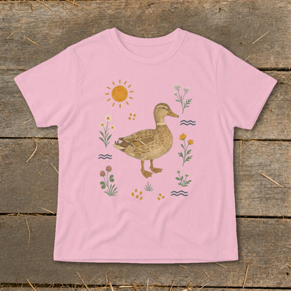 Pink t-shirt with a watercolor duck surrounded by flowers, sun, and waves.
