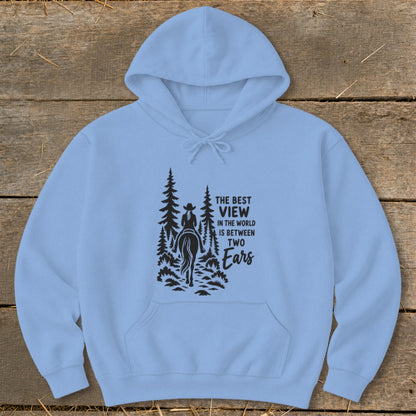 Light blue hooded sweatshirt with a black graphic of a horseback rider and text reading The Best View in the World is Between Two Ears.