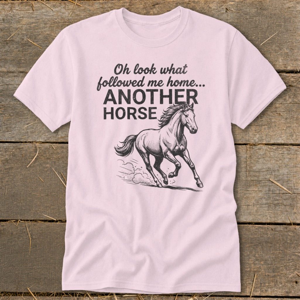 Pink t-shirt with text "Oh look what followed me home... ANOTHER HORSE" and a horse graphic.