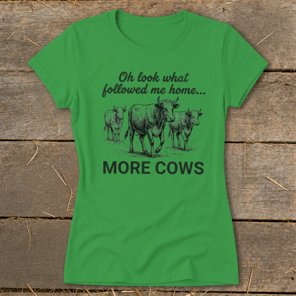 Green t-shirt with cows and text "Oh look what followed me home... MORE COWS".