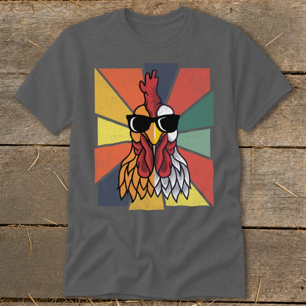 Rooster wearing sunglasses with a colorful geometric background on a t-shirt.