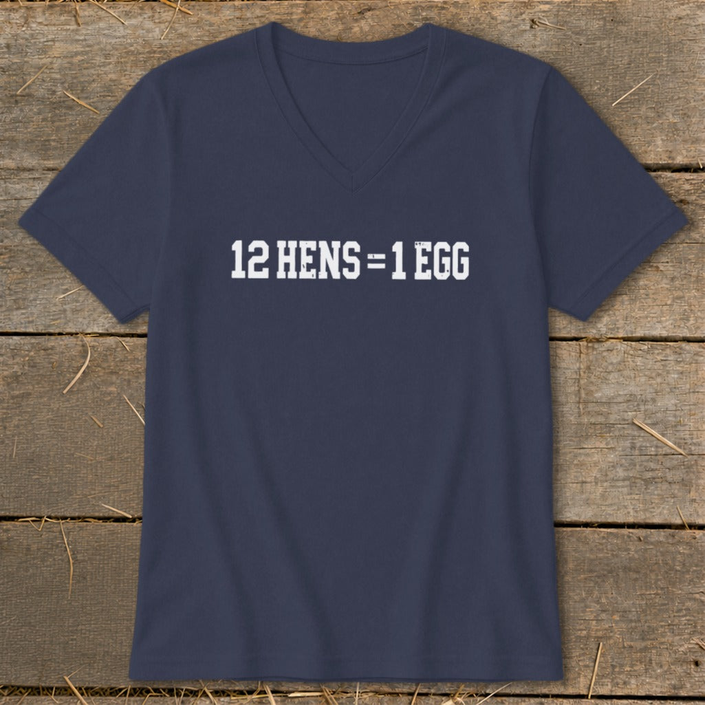Dark blue V-neck T-shirt with the white distressed text 12 HENS = 1 EGG displayed on the chest, lying flat on a wooden surface.