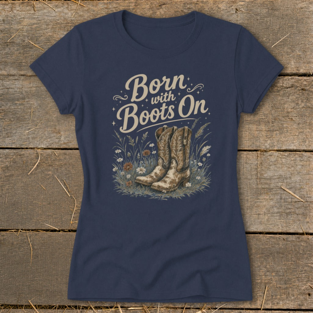 Navy t-shirt with "Born with Boots On" graphic featuring cowboy boots and wildflowers.
