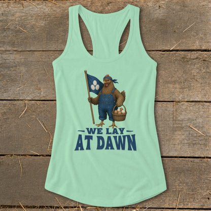 Mint green tank top with chicken graphic holding flag and basket of eggs, text reads "We Lay At Dawn."