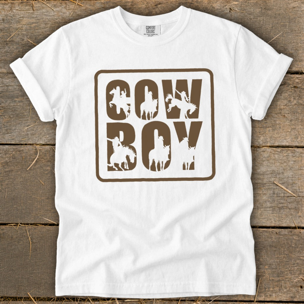 White t-shirt with "Cowboy" text and cowboy silhouettes in brown outline.