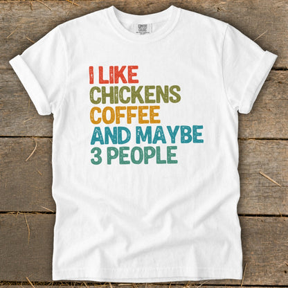 White t-shirt with text "I LIKE CHICKENS COFFEE AND MAYBE 3 PEOPLE".