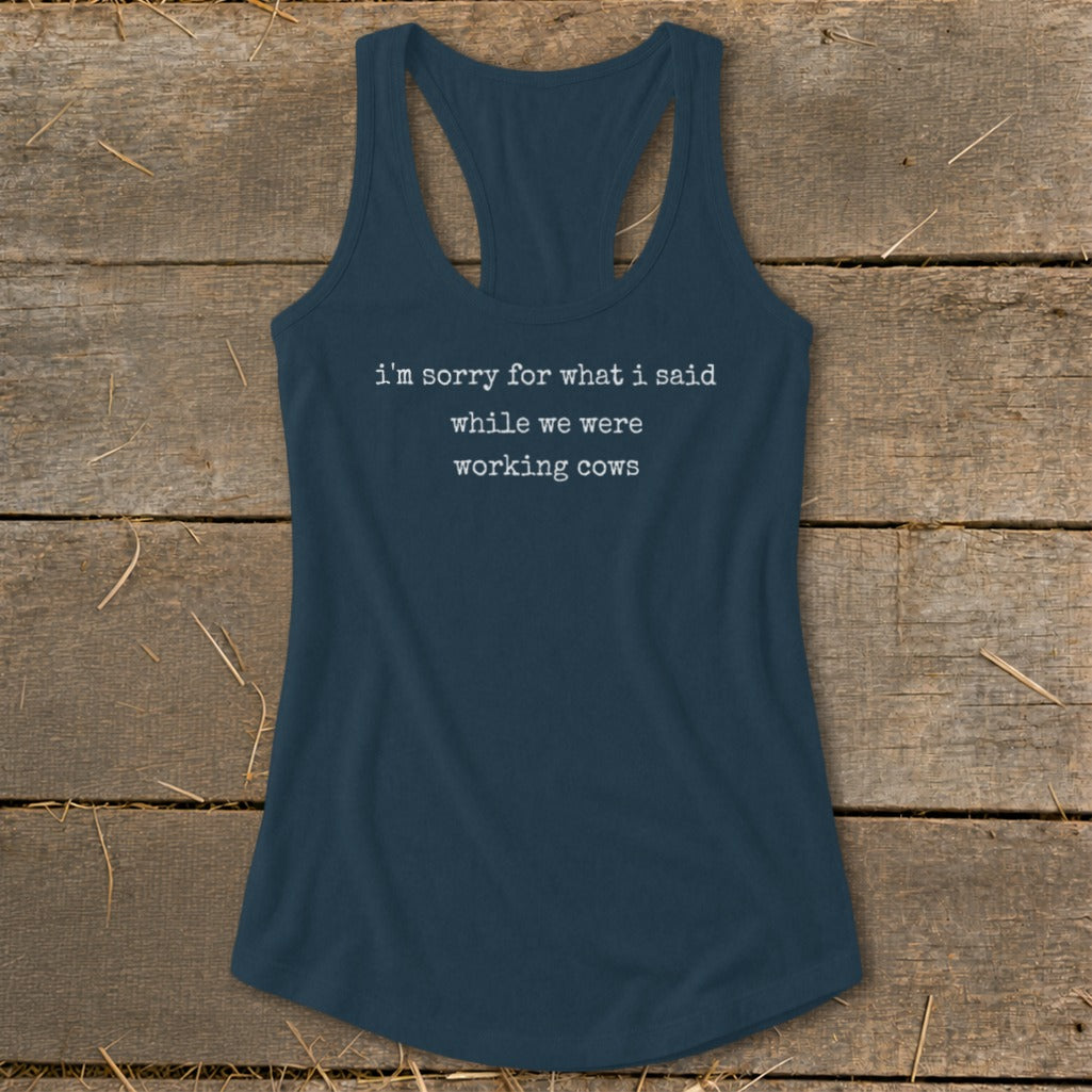 Navy racerback tank top with white text reading "i'm sorry for what i said while we were working cows".