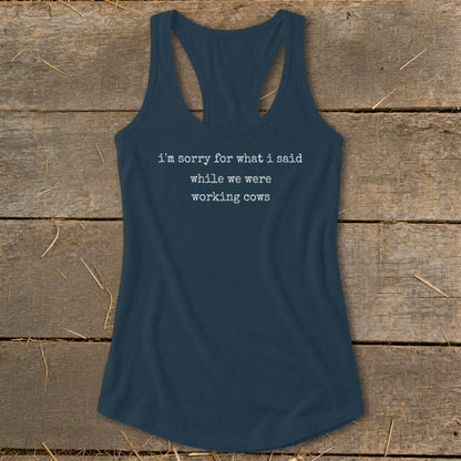 Navy racerback tank top with white text reading "i'm sorry for what i said while we were working cows".