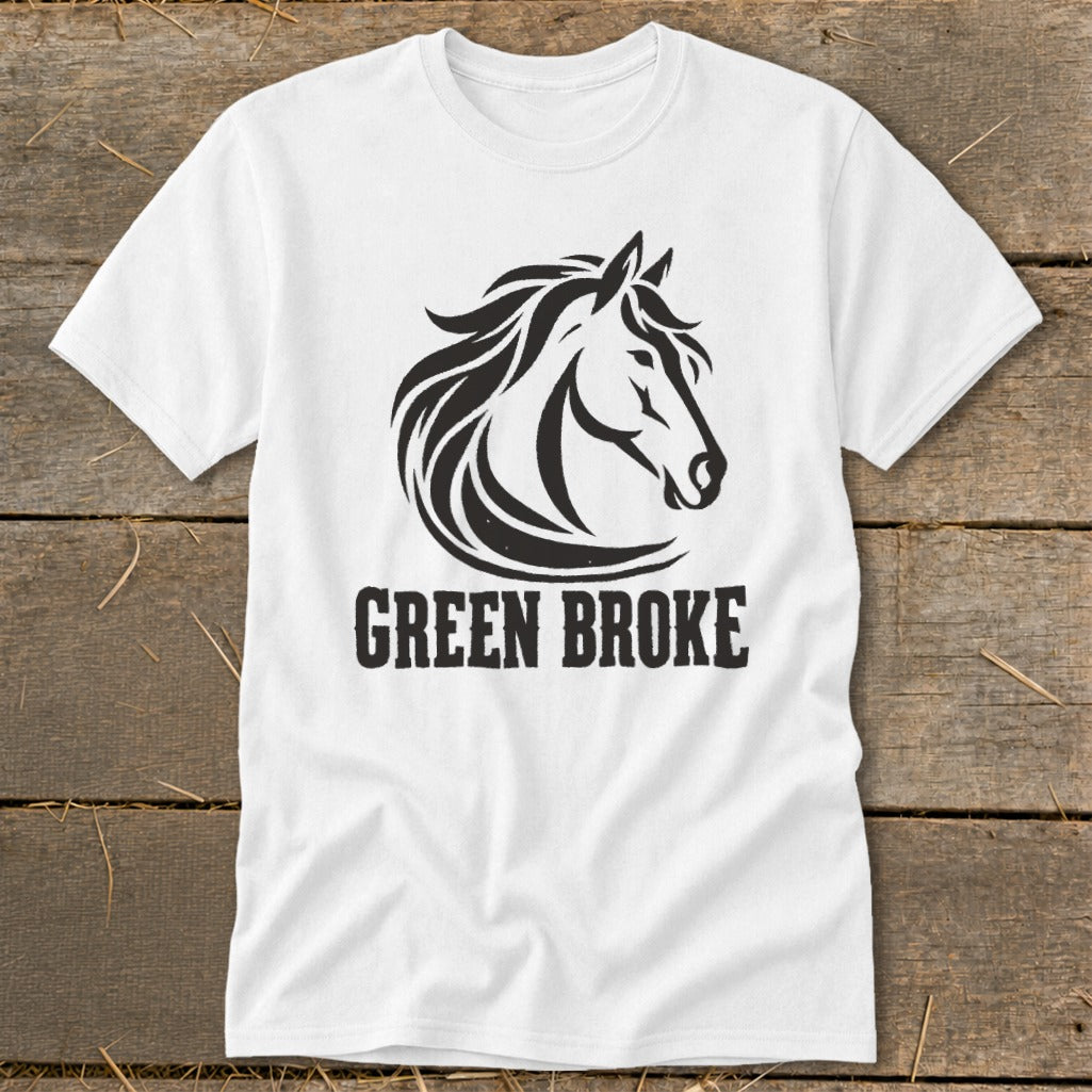 A white crewneck t-shirt featuring a black horse head graphic and the text GREEN BROKE on a rustic wooden background.