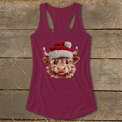 Highland cow wearing a Santa hat on a burgundy tank top.