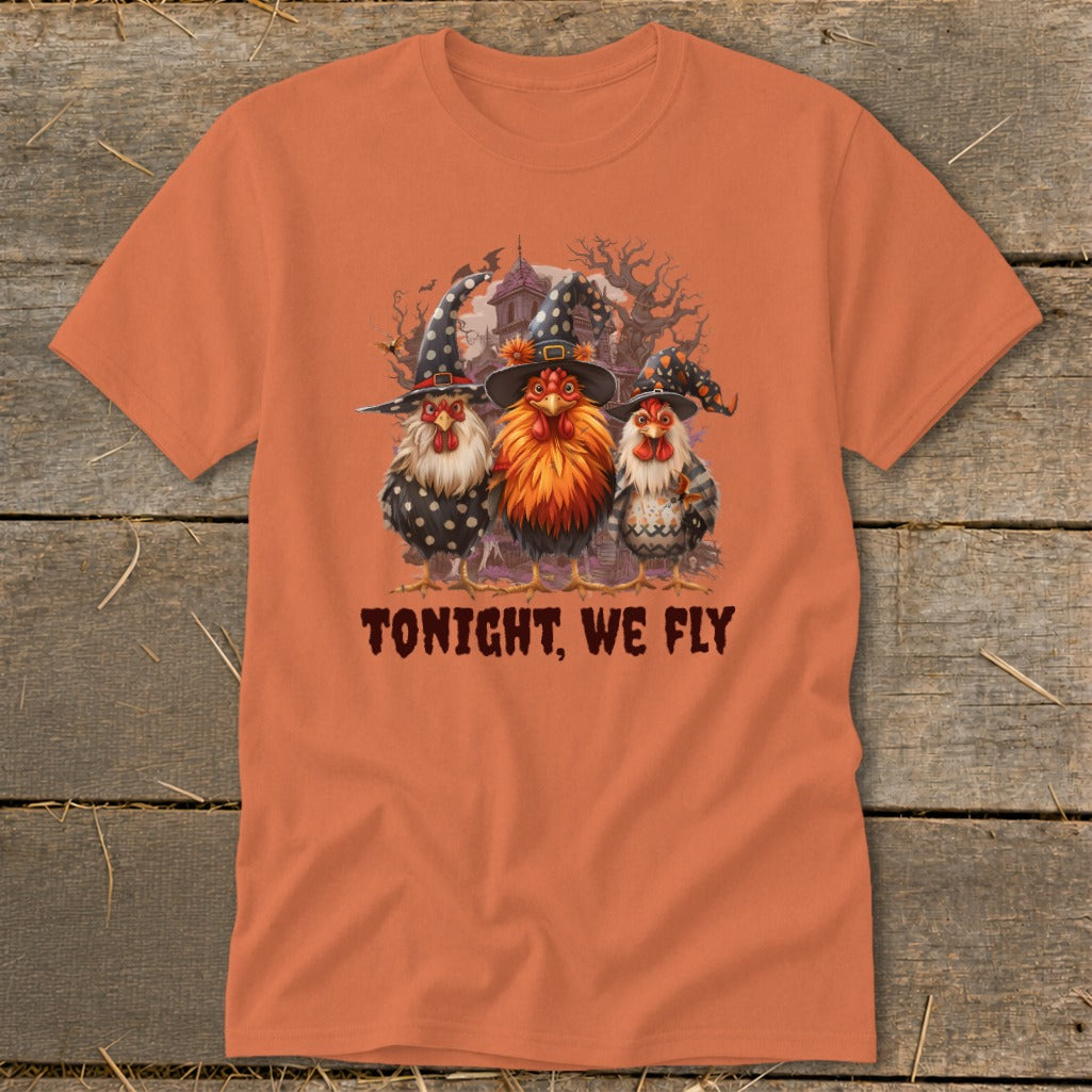 Three chickens in witch hats stand before a spooky background with text "TONIGHT, WE FLY".
