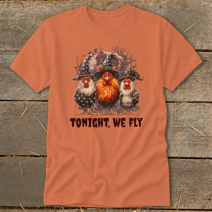 Three chickens in witch hats stand before a spooky background with text "TONIGHT, WE FLY".