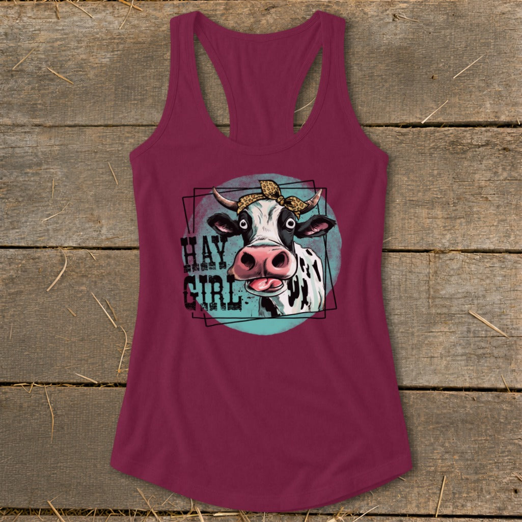 Cow with leopard print bandana and text "HAY GIRL" on a maroon tank top.