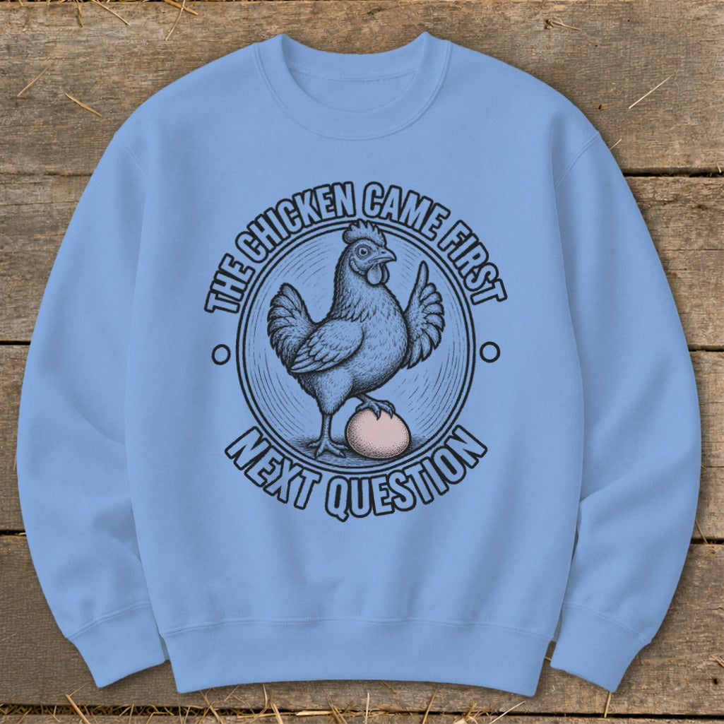 Light blue sweatshirt with a chicken, egg, and text "The Chicken Came First Next Question".