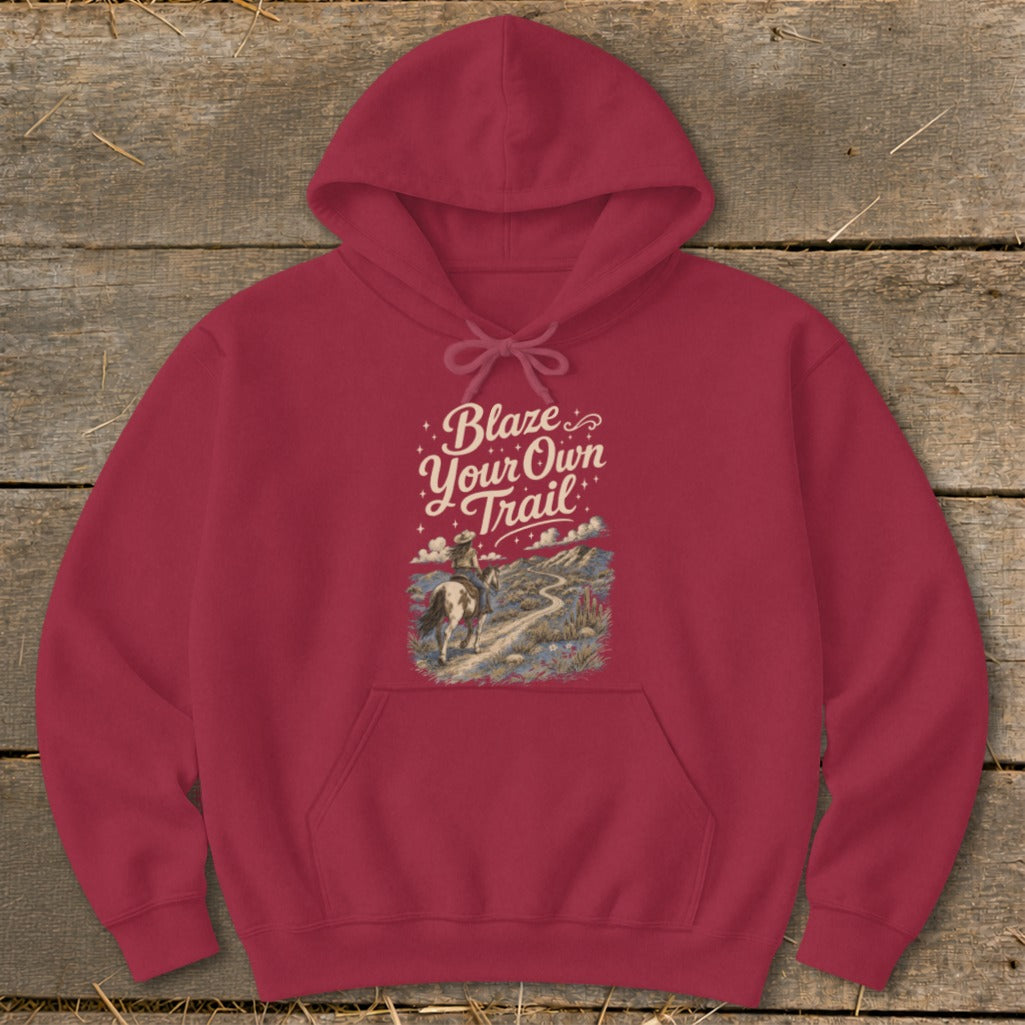 Red hoodie with "Blaze Your Own Trail" text over desert scene and cowboy on horseback.