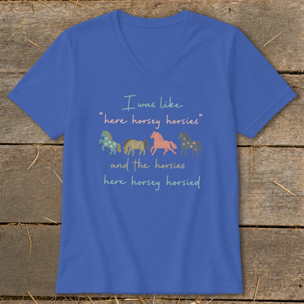 Blue v-neck shirt with text and four colorful horses.