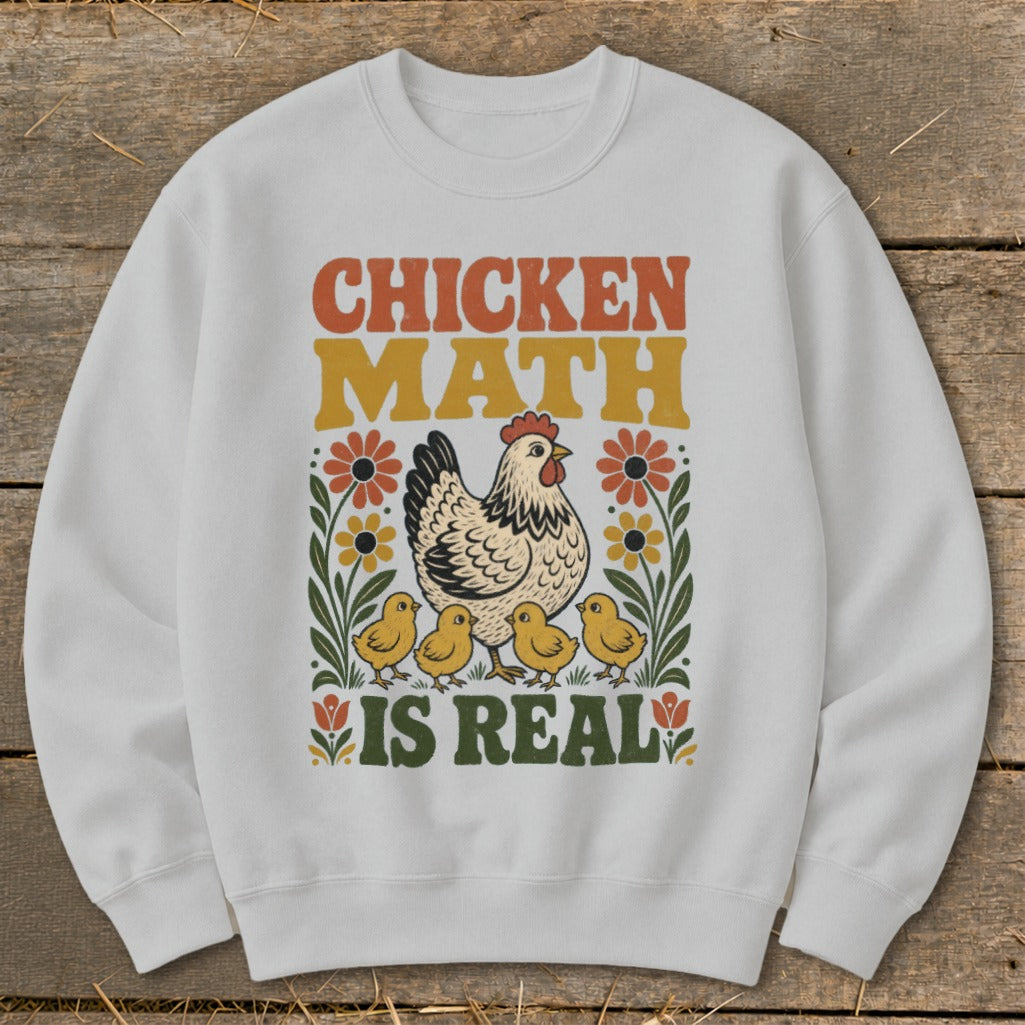White sweatshirt with retro graphic: chicken, chicks, flowers, and text "CHICKEN MATH IS REAL".