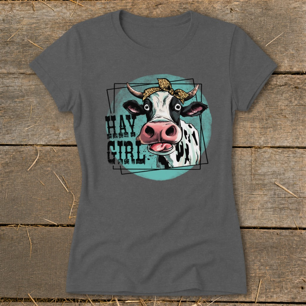T-shirt graphic with a cow wearing a bandana and the text "HAY GIRL".