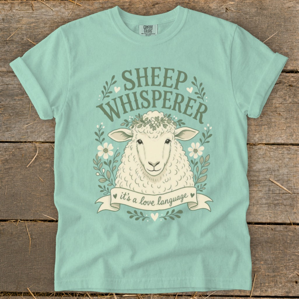 Mint t-shirt with "Sheep Whisperer" text and a sheep wearing a flower crown.