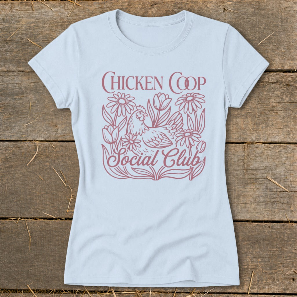 Light blue t-shirt with "CHICKEN COOP Social Club" text and chicken amongst flowers.