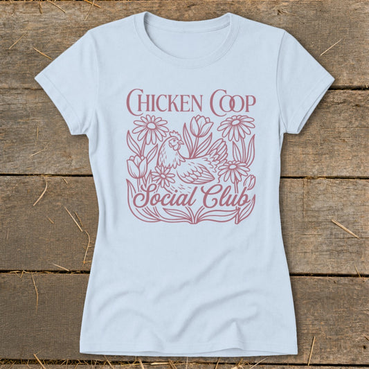 Light blue t-shirt with "CHICKEN COOP Social Club" text and chicken amongst flowers.
