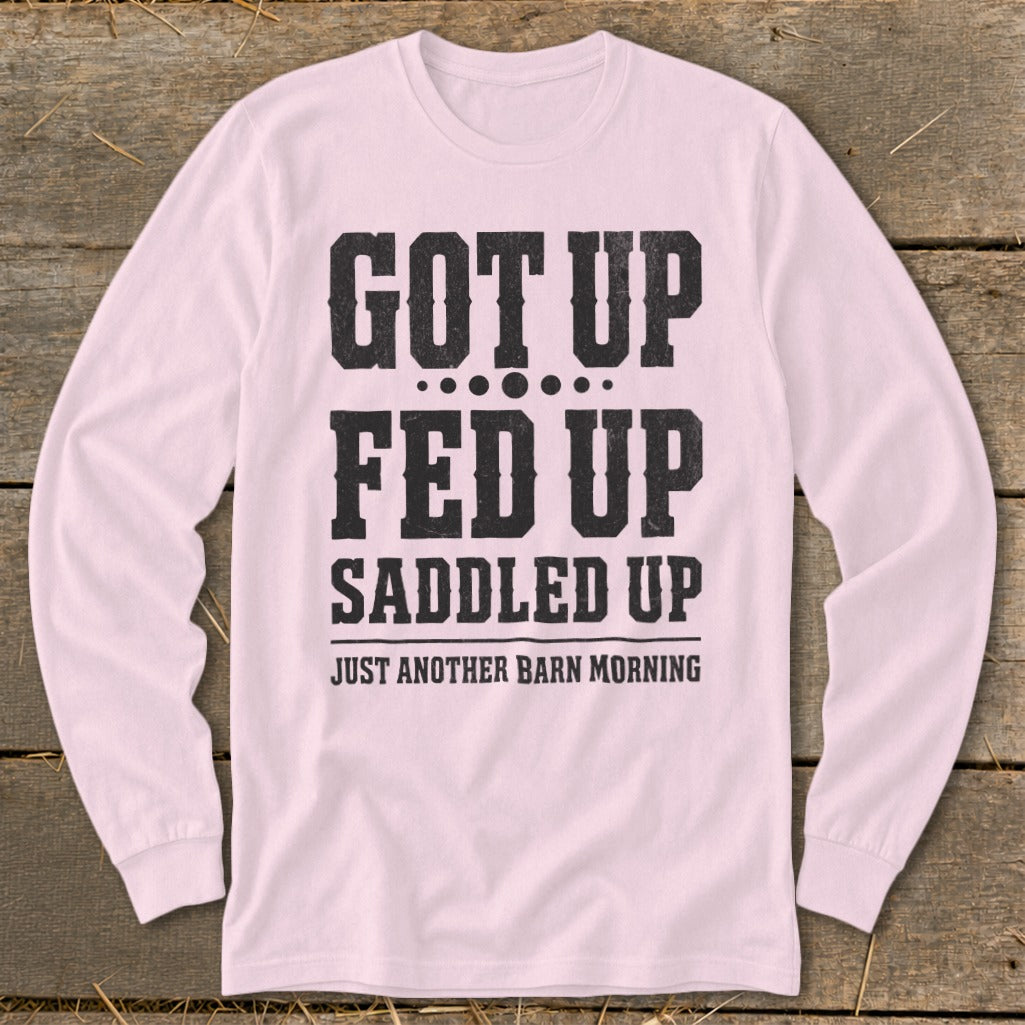 Pink long-sleeve shirt with "GOT UP FED UP SADDLED UP JUST ANOTHER BARN MORNING" text.