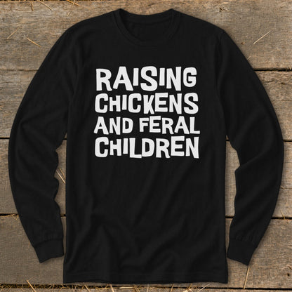 Black long sleeve shirt with white text reading "Raising Chickens and Feral Children".