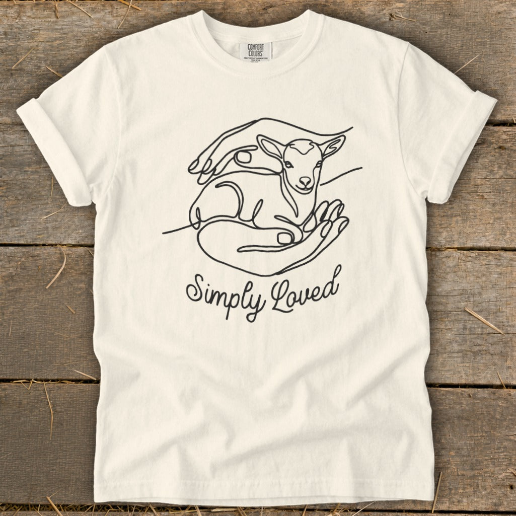 Cream t-shirt with line drawing of lamb in cupped hands, text "Simply Loved".