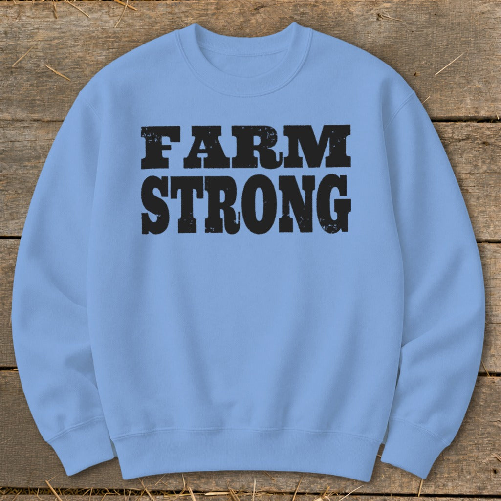Light blue crewneck sweatshirt featuring the black distressed text FARM STRONG centered on the chest.