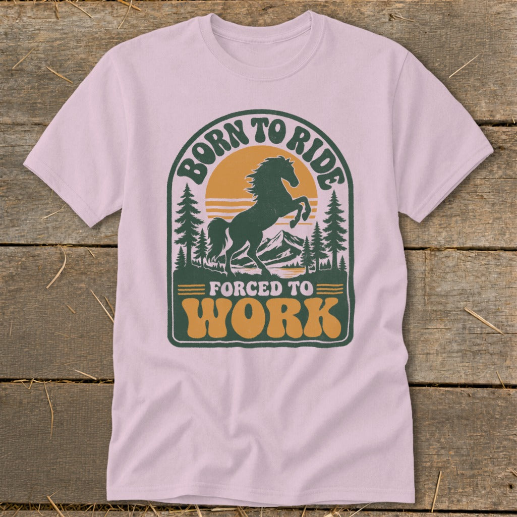Pink t-shirt with a graphic that says "BORN TO RIDE FORCED TO WORK" and a horse.