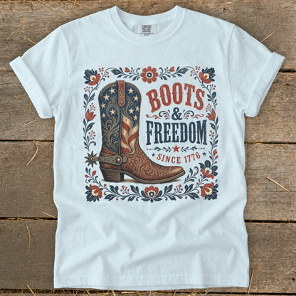 White t-shirt with "Boots & Freedom Since 1776" graphic featuring a patriotic boot.