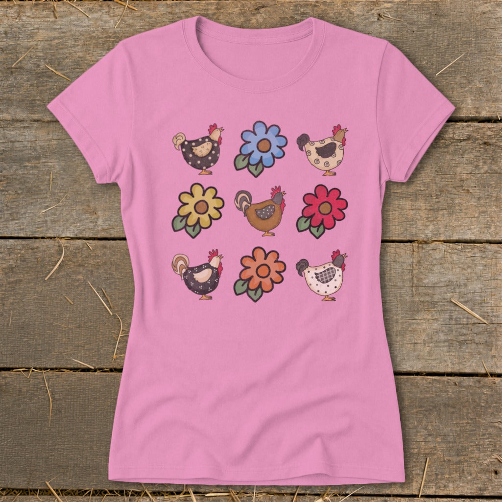 Pink t-shirt with a repeated pattern of cartoon chickens and flowers.