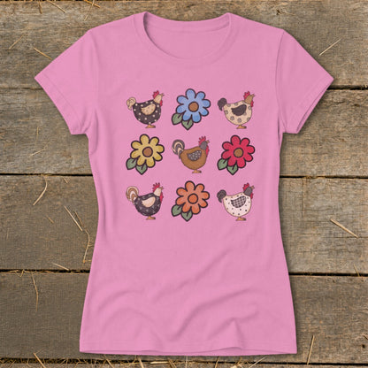Pink t-shirt with a repeated pattern of cartoon chickens and flowers.