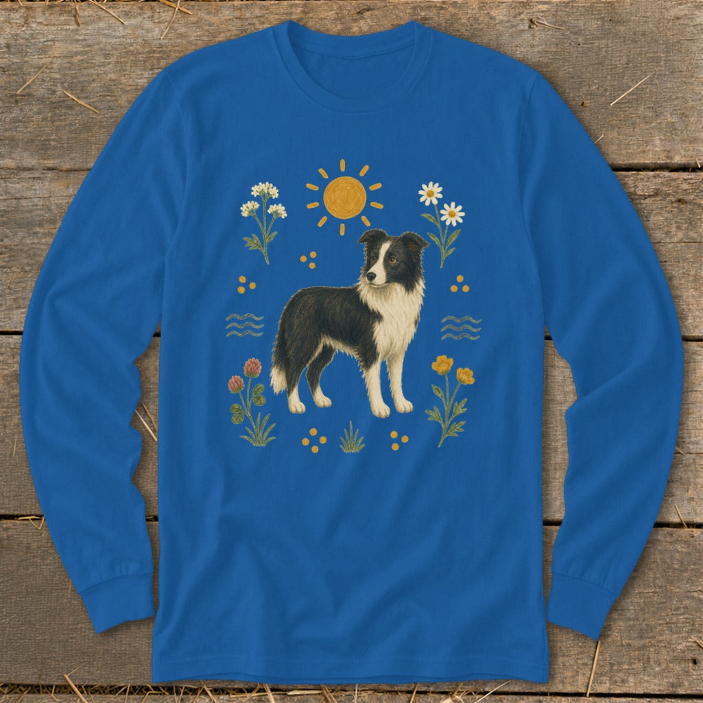 Blue long-sleeve shirt with a black and white dog surrounded by flowers and the sun.