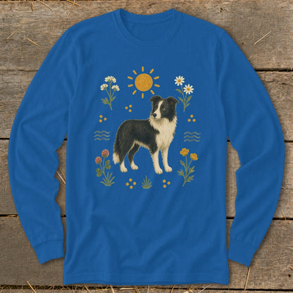 Blue long-sleeve shirt with a black and white dog surrounded by flowers and the sun.