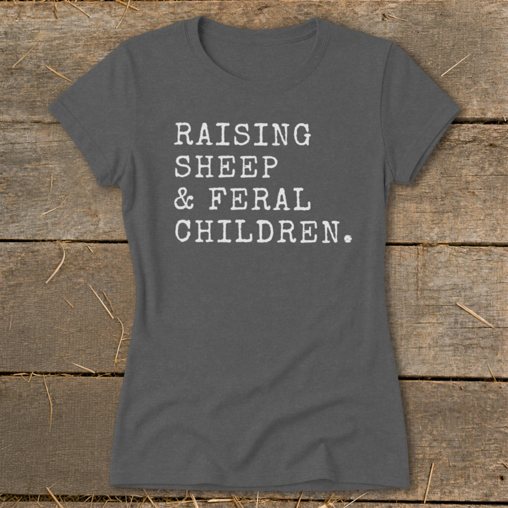 Dark gray t-shirt with white text: Raising Sheep & Feral Children.