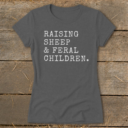 Dark gray t-shirt with white text: Raising Sheep & Feral Children.