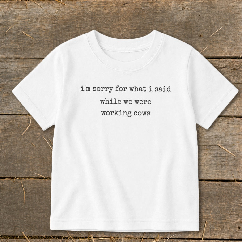 White t-shirt with text "i'm sorry for what i said while we were working cows".