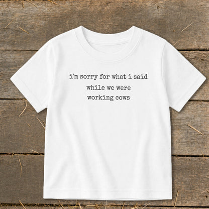 White t-shirt with text "i'm sorry for what i said while we were working cows".