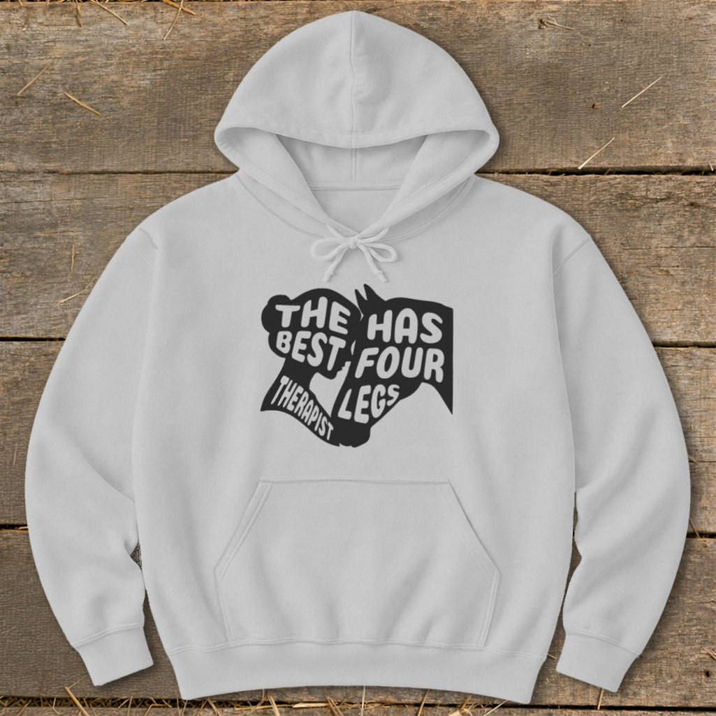 White hoodie with text graphic: "THE HAS BEST FOUR THERAPIST LEGS".