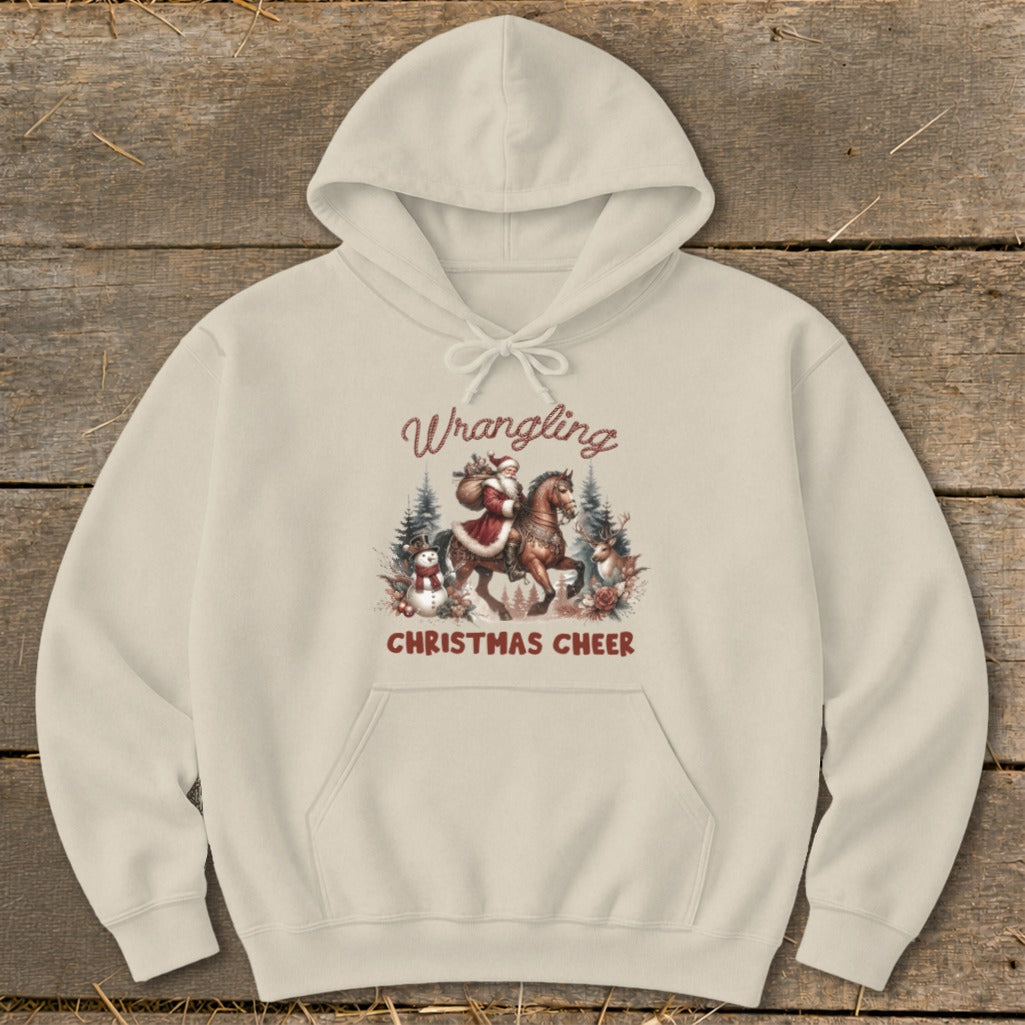 Cream hoodie with "Wrangling Christmas Cheer" text and Santa on a horse graphic.