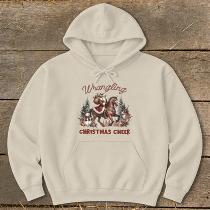 Cream hoodie with "Wrangling Christmas Cheer" text and Santa on a horse graphic.