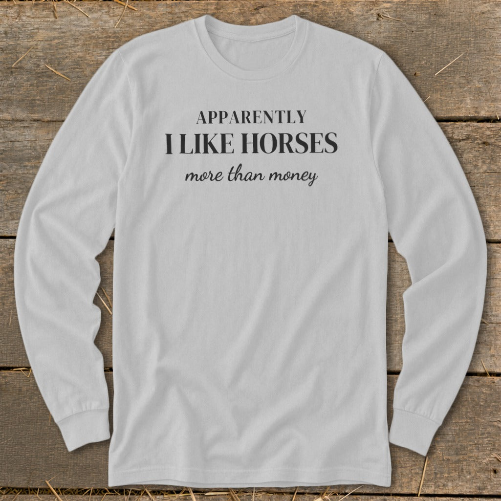 White long sleeve shirt with text "Apparently I like horses more than money".
