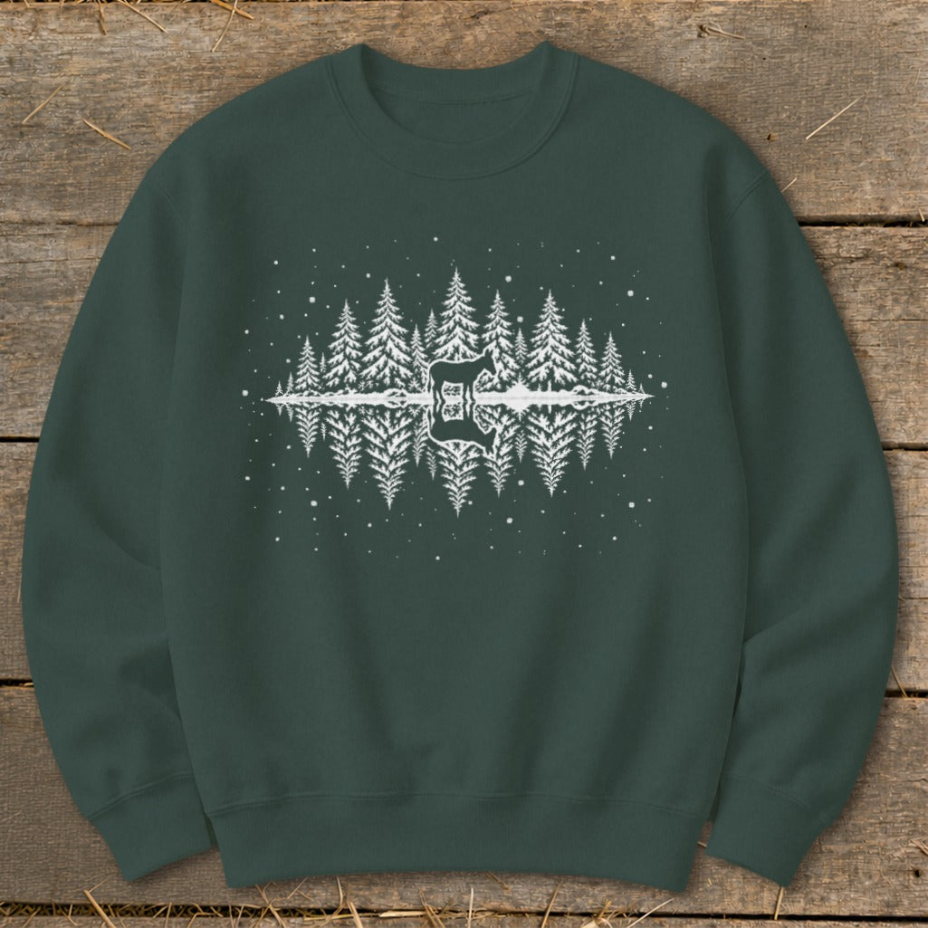 Dark green sweatshirt with white graphic of mirrored pine trees and a deer silhouette.