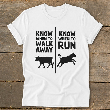 White t-shirt with black text and cow silhouettes that say "Know When to Walk Away" and "Know When to Run".